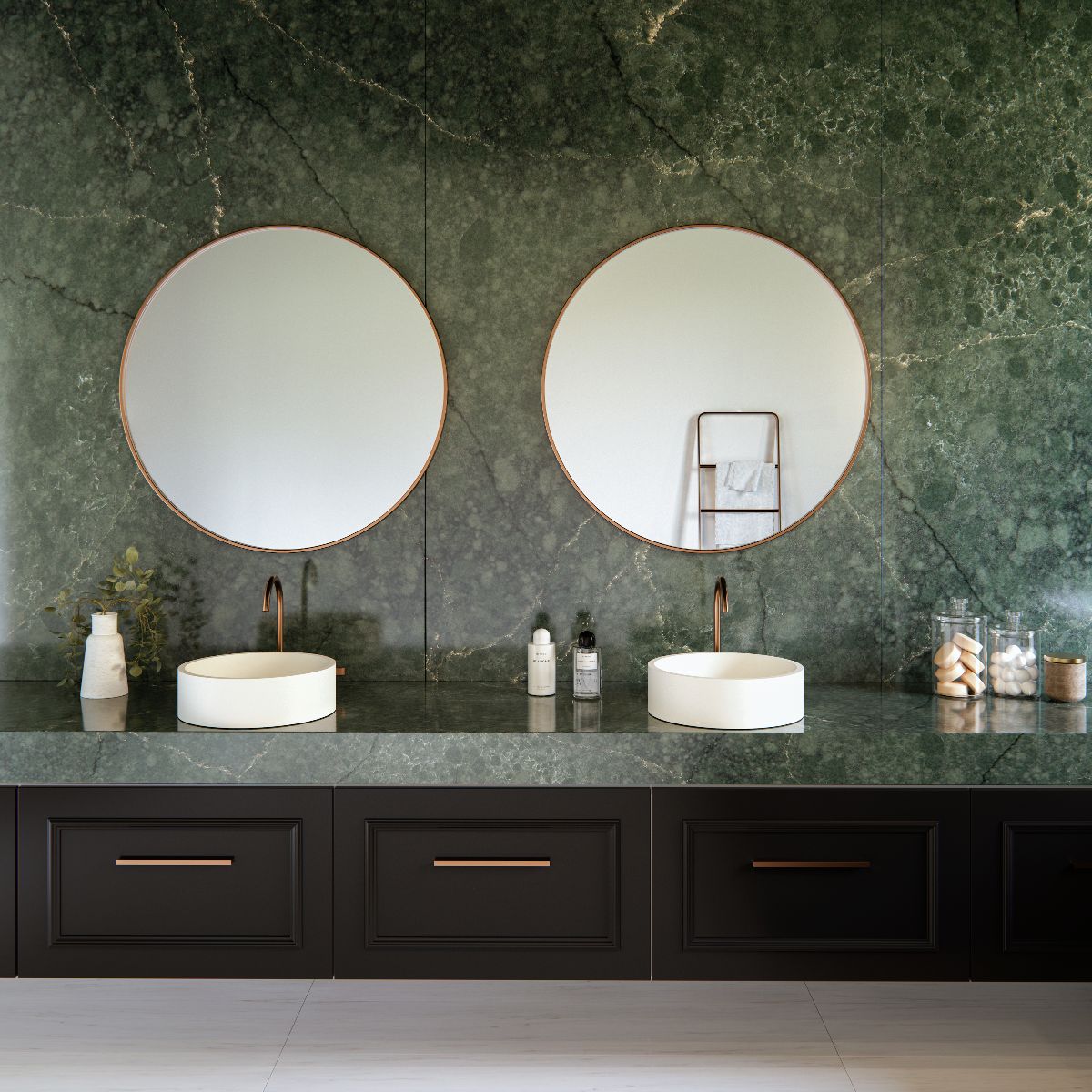 Green bathroom with pretty green surfaces, wall-mounted vanity, countertop basins, and copper accents.