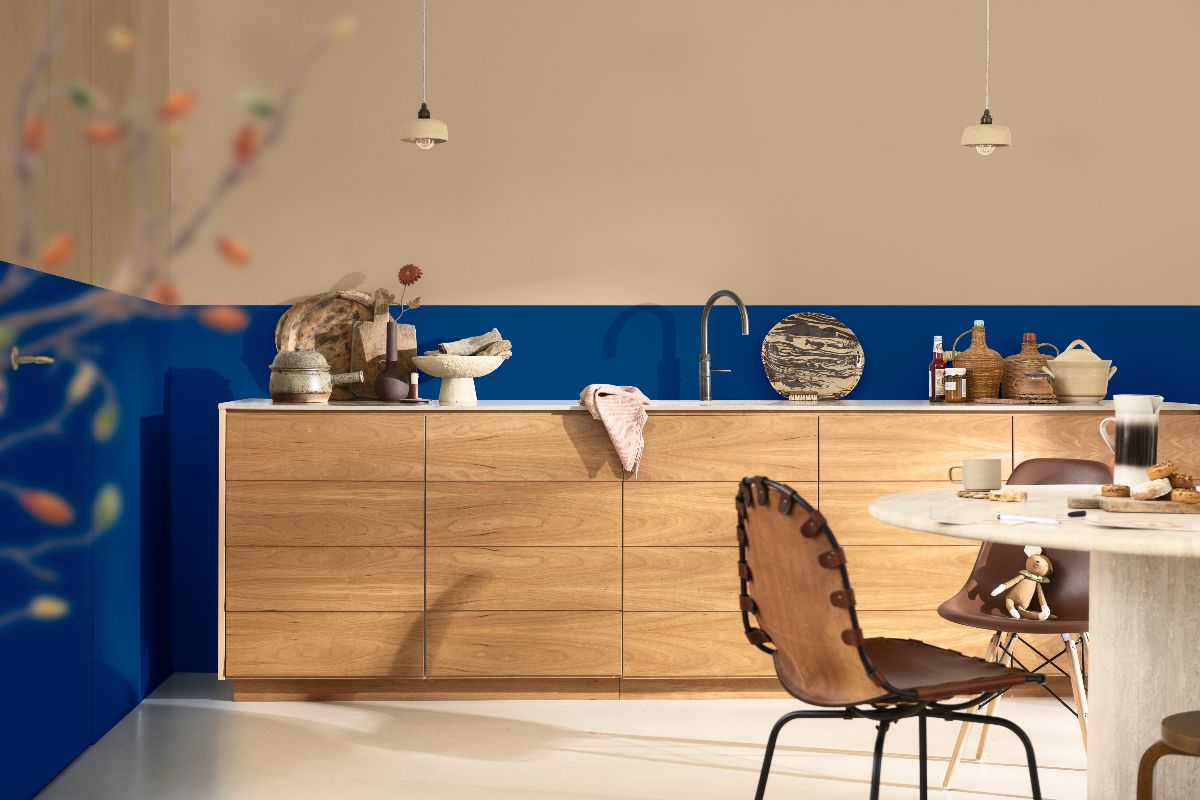 Wood kitchen cabinetry with neutral and vibrant blue paint on the walls.