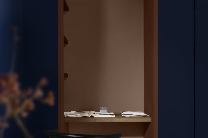 A home office nook painted in deep brown and inky blue.