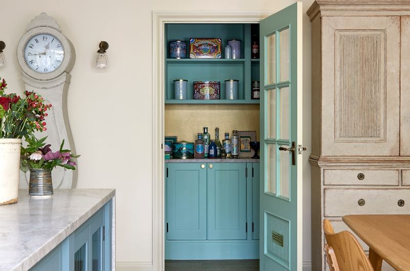 A view of the walk-in pantry painted in blue with a metallic splashback.