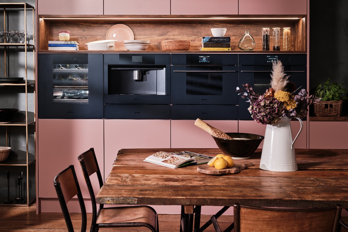 Pink kitchen design with built-in appliances.