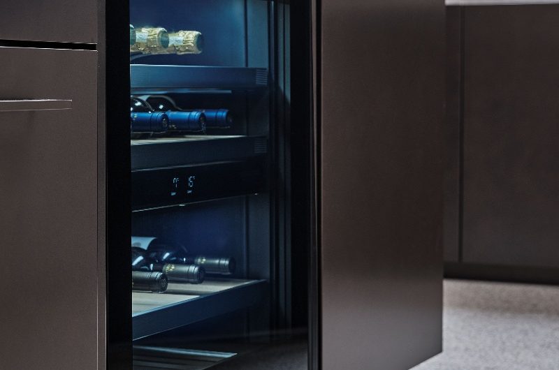 Kitchen with handleless unit and built-in wine fridge for entertaining.
