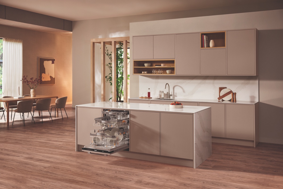 A neutral space with wood flooring, sleek cabinets, and white work surfaces.