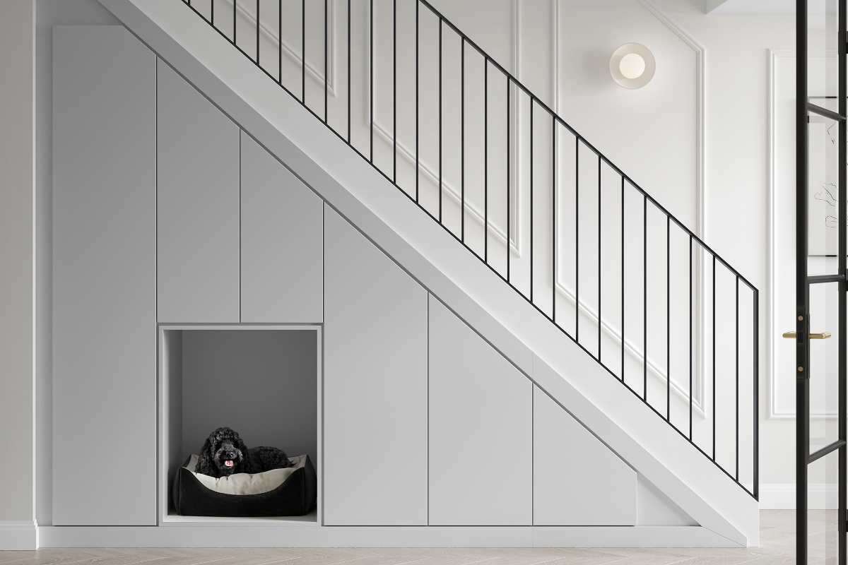A staircase with storage and a pet bed underneath.
