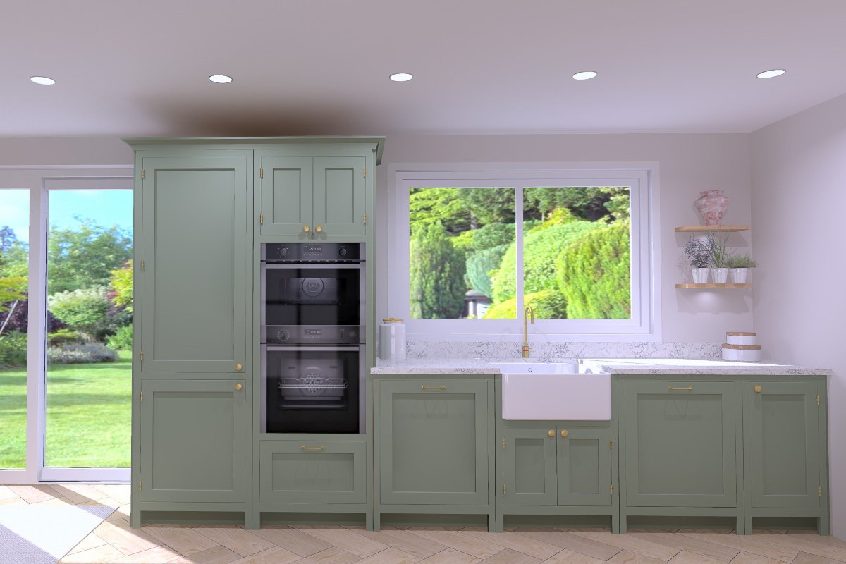A closeup at the cabinetry run with sage green cabinets, veiny surfaces, built-in appliances and a sink zone with a butler bowl and brass tap.