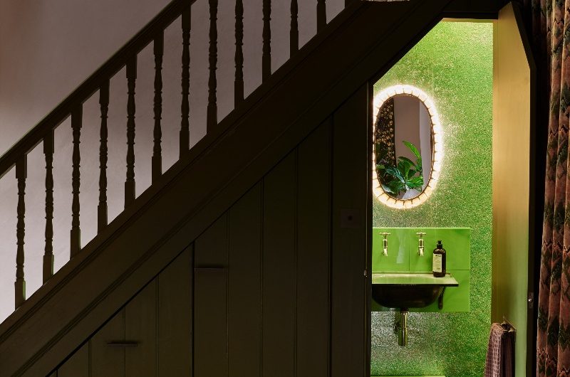 A cloakroom drenched in shades of green.