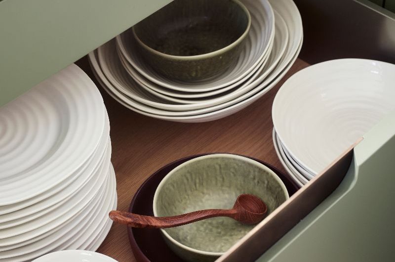Closeup at an open drawer with crockery.