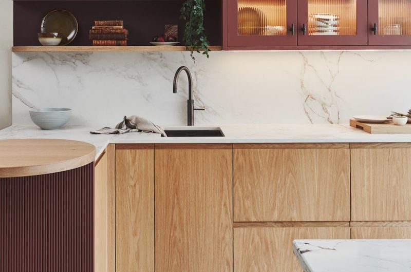 A modern kitchen with layers of colour, materials and textures, and clever features such as illuminated cabinetry.