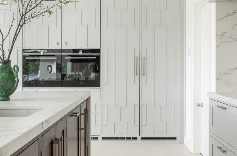 Bespoke kitchen cabinetry with a geometric pattern and a wooden island.