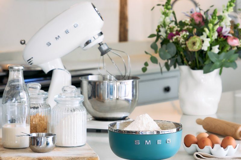 Kitchen island with a digital scale and mixer in the background.