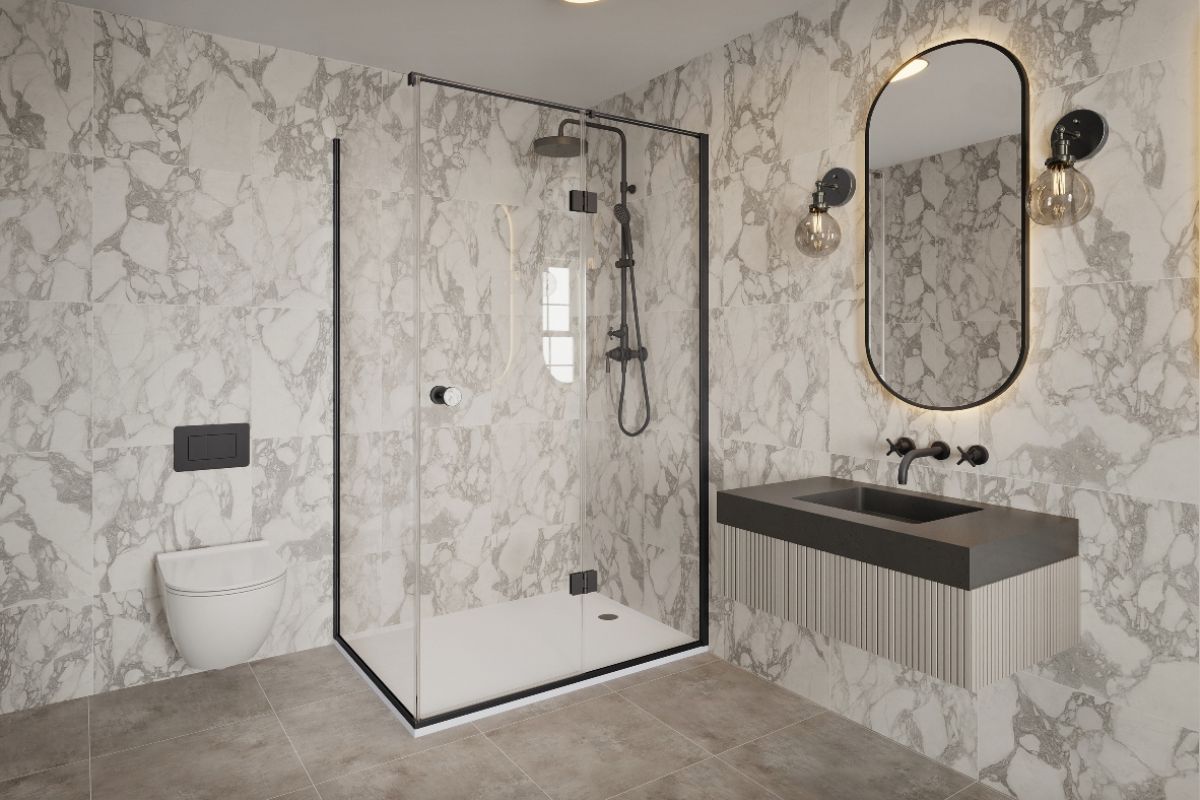 A stone-clad bathroom with a compact shower design, a fluted vanity unit with built-in basin, and LED mirror.