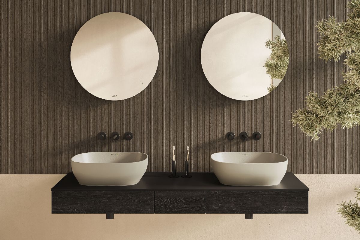Spa like bathroom with fluted wood tiles, wood furniture, recycled basins, circular mirrors and black brassware.