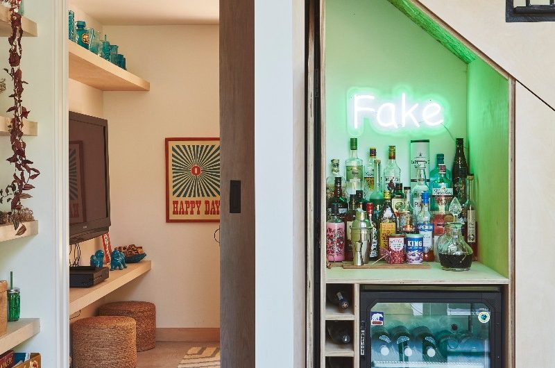 A bar and home office tucked under the stairs concealed with pocket doors.
