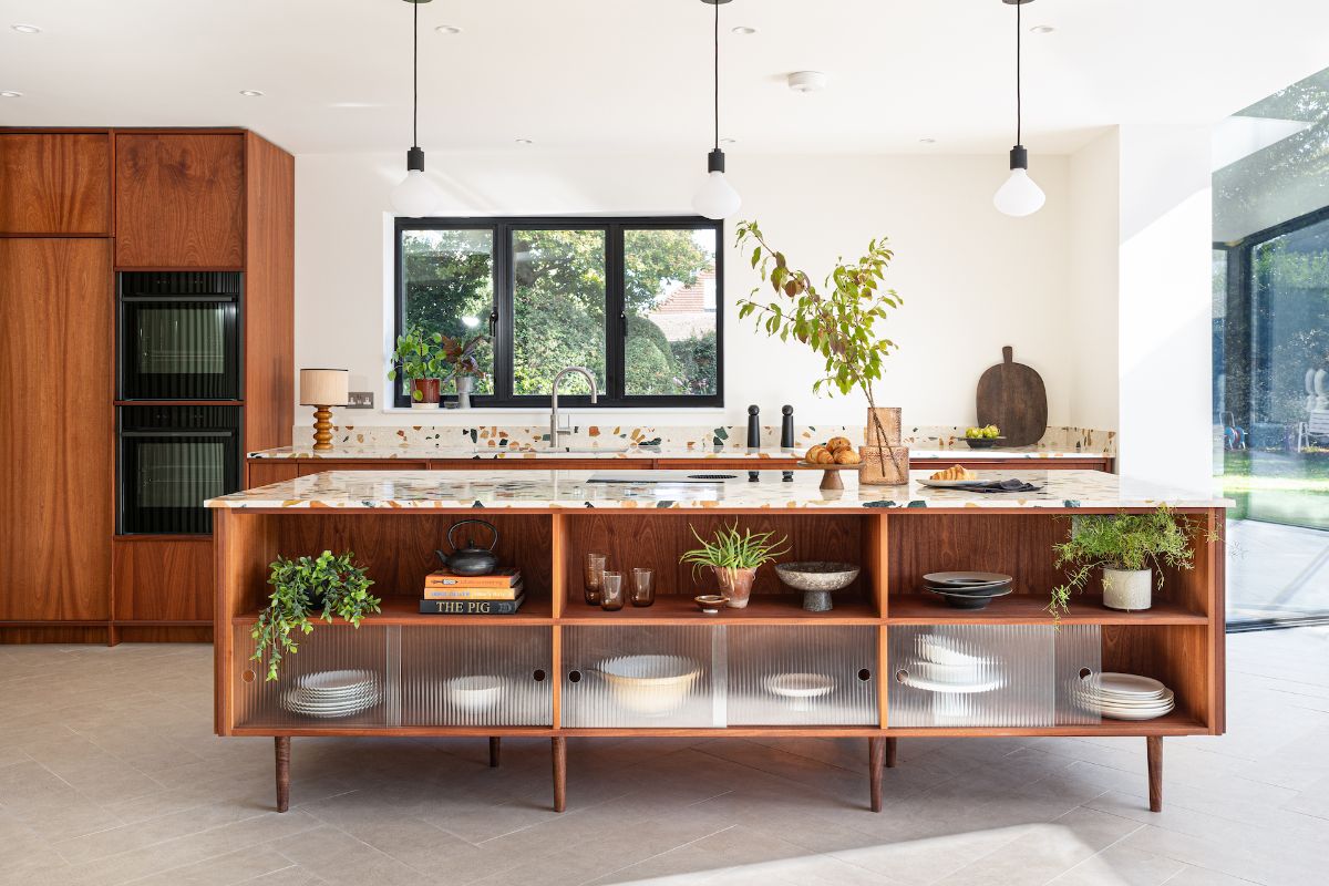 Bespoke wood kitchen with terrazzo surfaces, built-in appliances, minimalist, Japandi decor, and a central island with storage.