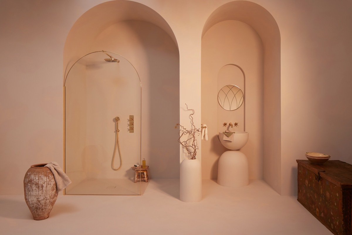 Spa space with curved walls, curved shower enclosure and gold brassware.