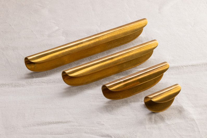 Closeup at gold, curved handles at Decorex 2025.