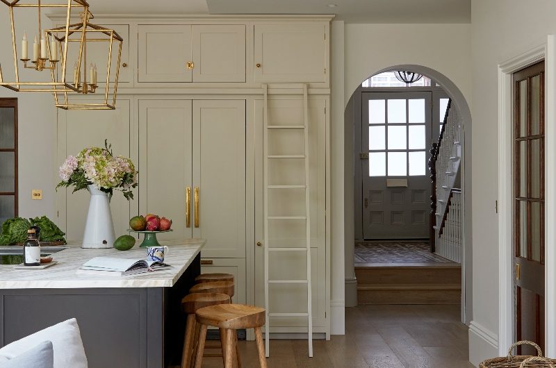 A classic scheme with floor-to-ceiling cabinetry, a ladder, an arched entryway.