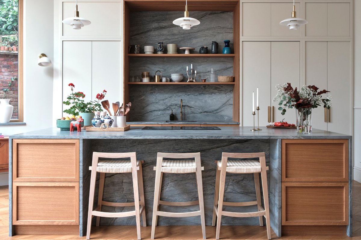 A Japandi-inspired scheme with modern cabinetry, a stone and wood island, and minimalist decor.