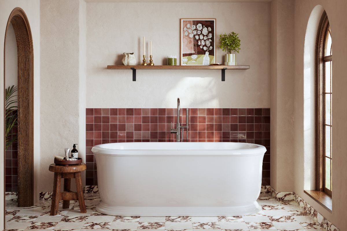 A charming bathroom design with burgundy wall tiles, marble floor tiles, a white freestanding tub, and wood open shelf.