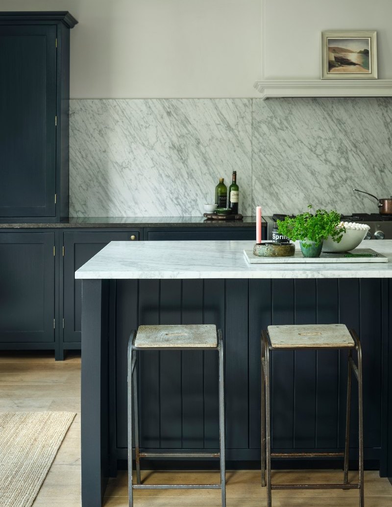 Navy kitchen design with classic cabinetry, a central island and marble surfaces.
