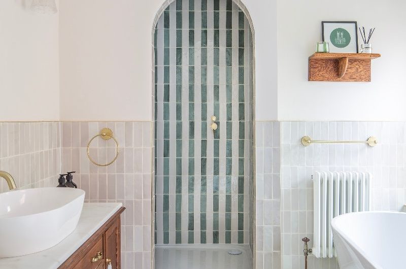 Bathroom inspiration for the loft conversion with a curved shower and striped tiles.