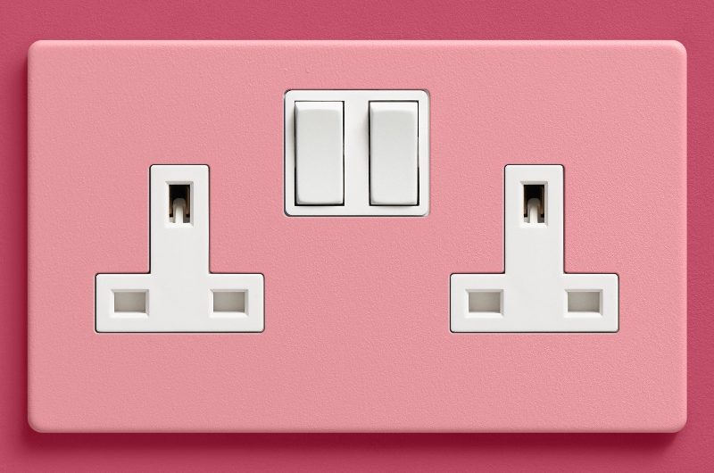 A pink wall with a pink power solution with white detailing.