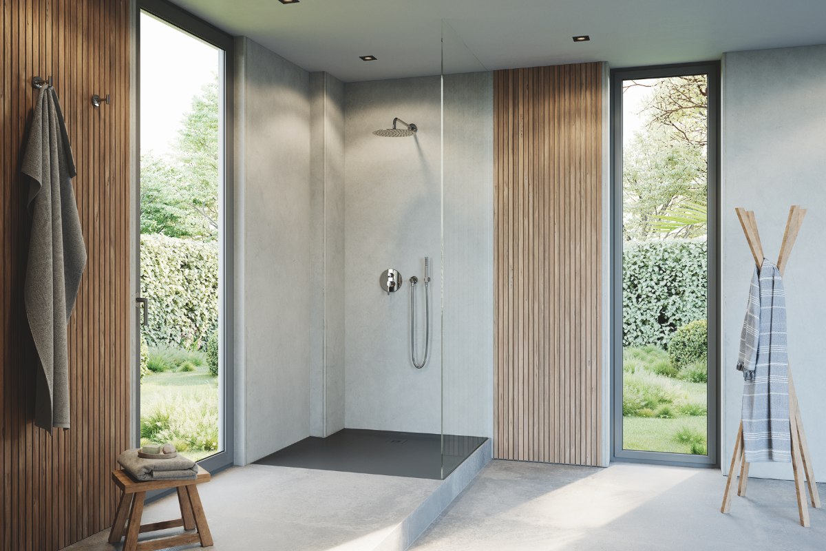 A spa-like bathroom with neutral wall and floor coverings, wood panelling, and a minimalist shower area with a stone resin tray.