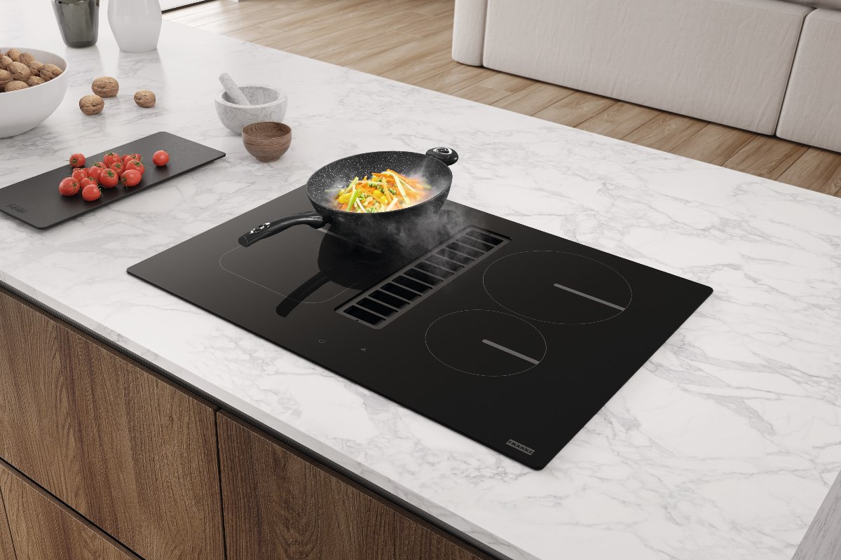 A central island with a small cooking appliances with integrated extraction.
