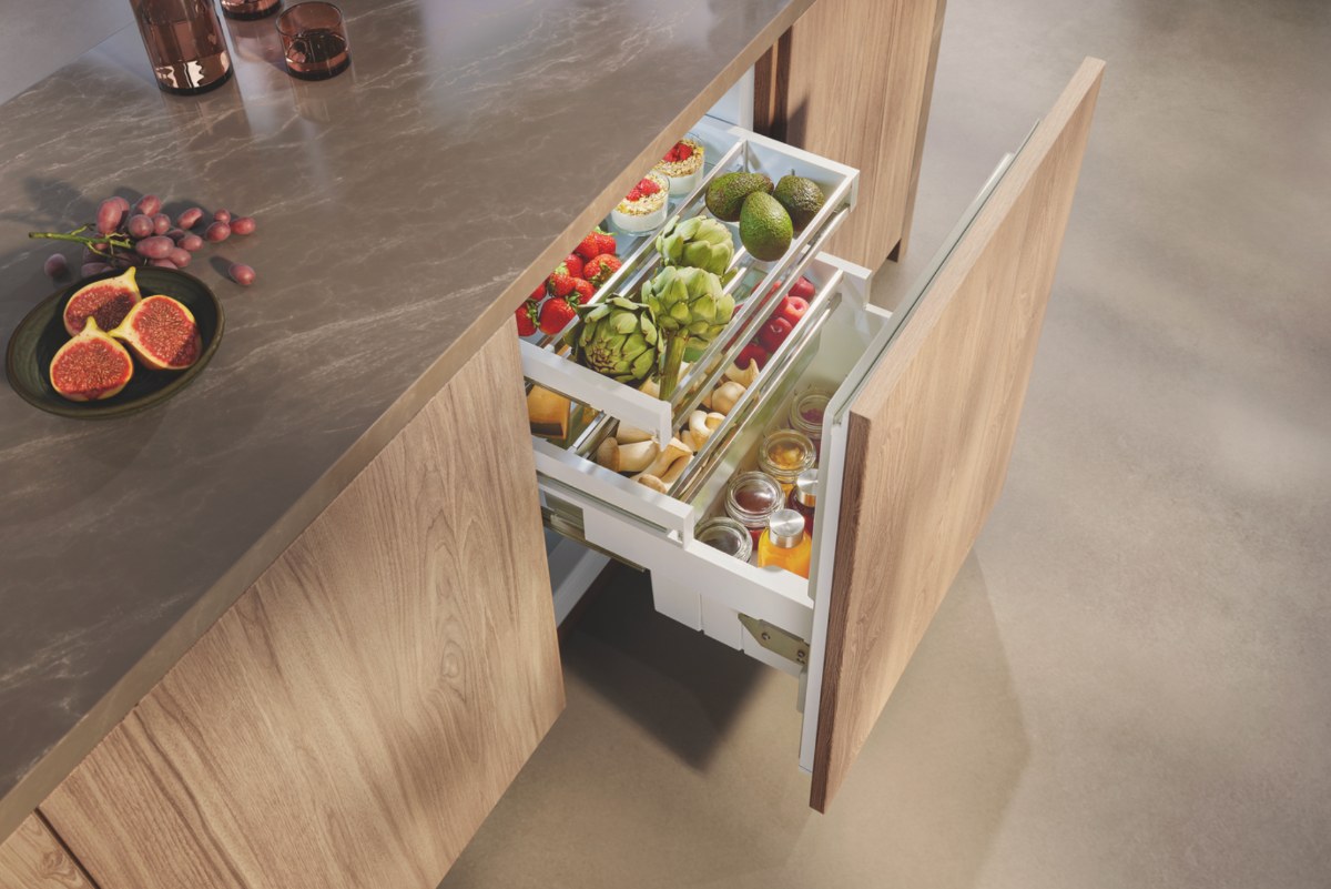 Undercounter refrigeration in a wood kitchen.