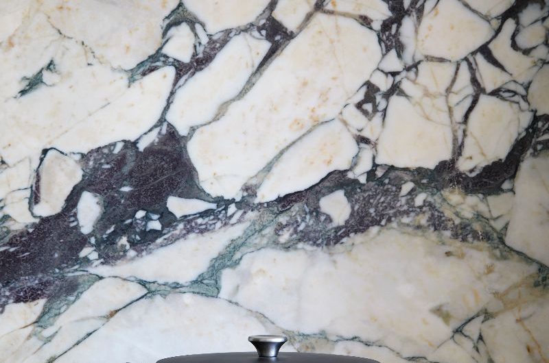 Closeup at a marble splashback behind the range cooker.