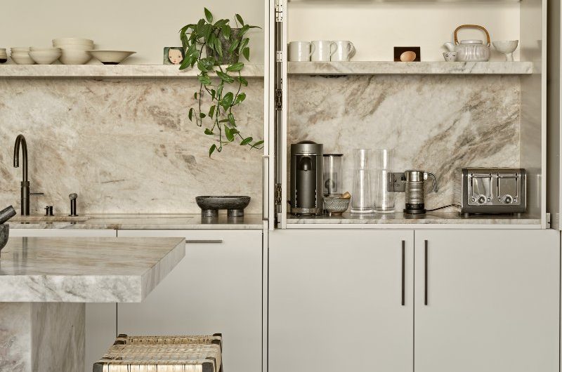 Closeup at the breakfast bar with small appliances and crockery, which can be concealed behind pocket doors.