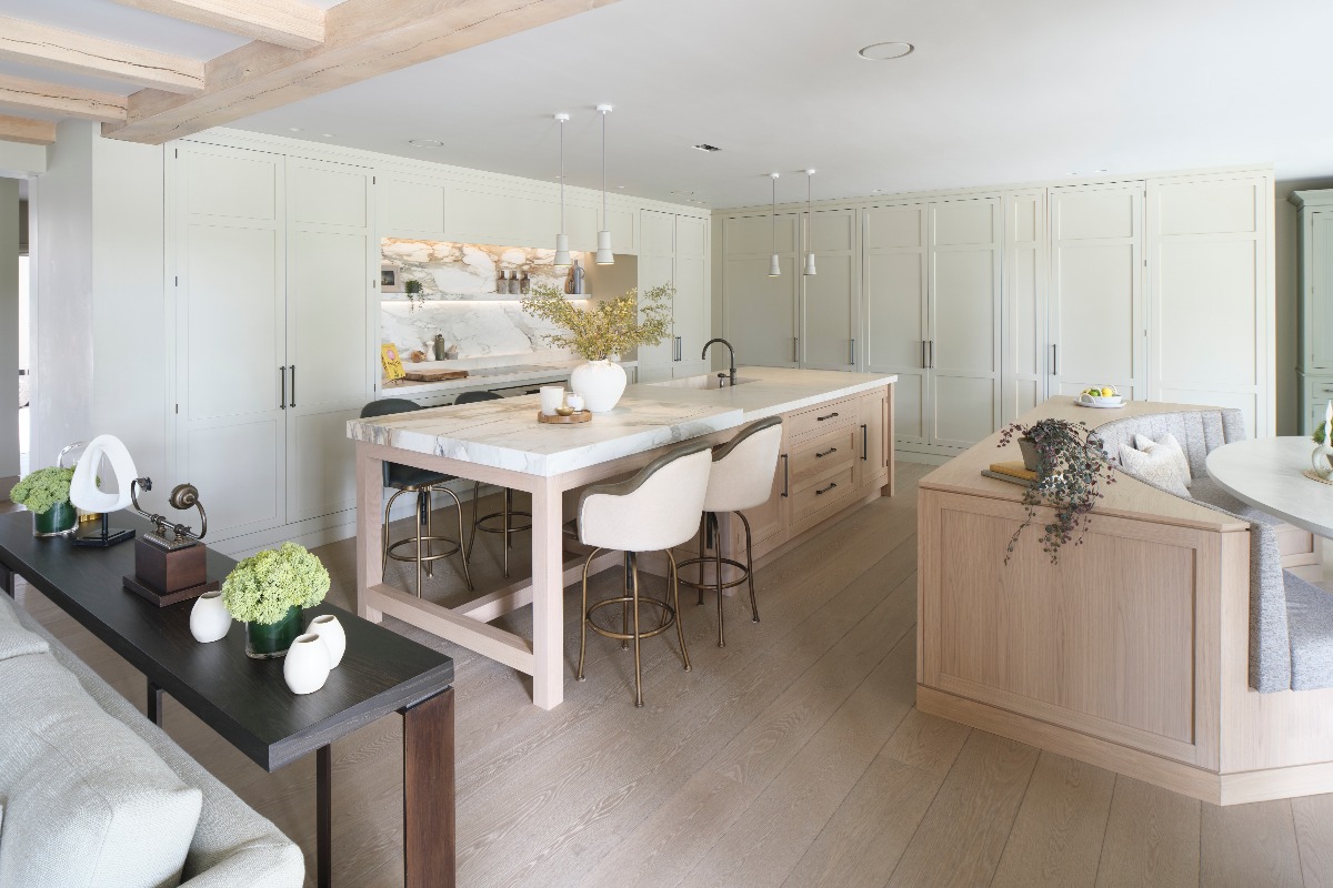 An open-plan kitchen with an island and a high table extension, comfortable seating area for casual dining and drinks.