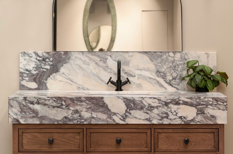 Real marble takes centre stage in a wood vanity unit with Breccia Capraia marble top.