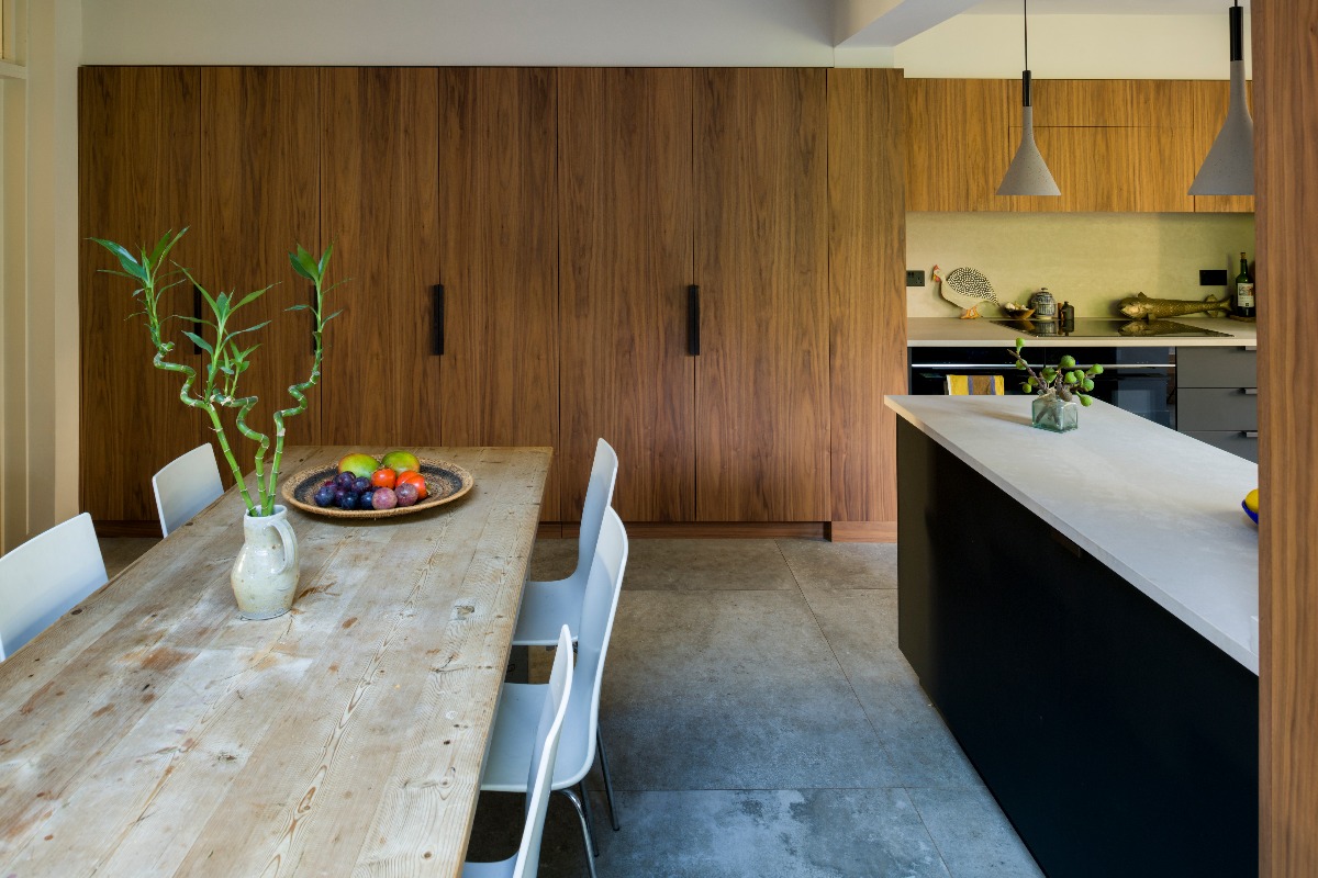 Mid-century modern kitchen design with tall cupboards concealing utility storage, larder, breakfast cupboard.