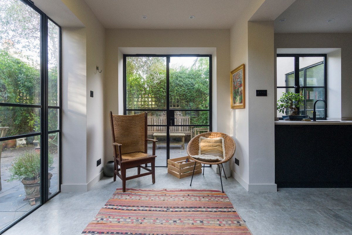 A cosy seating area near glazing which enjoys garden views.