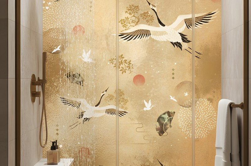 A shower with striking gold panel and gold-framed enclosure.