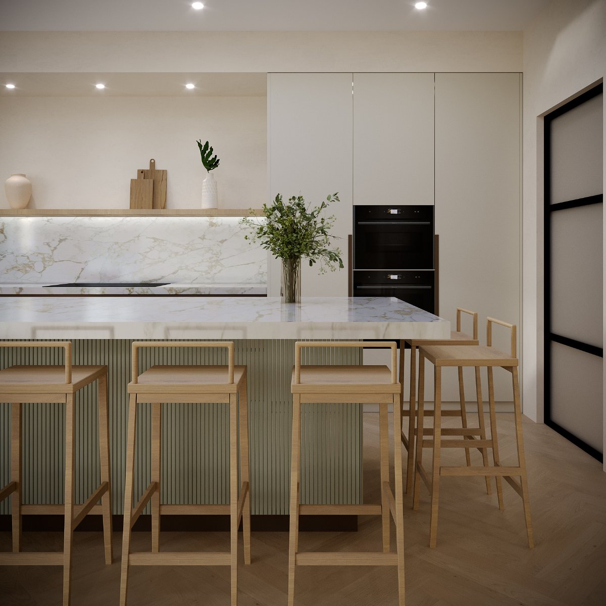 Closeup at the fluted kitchen island with a painted base and topped with statement worktop, with a run of cabinets behind it and a hob area.