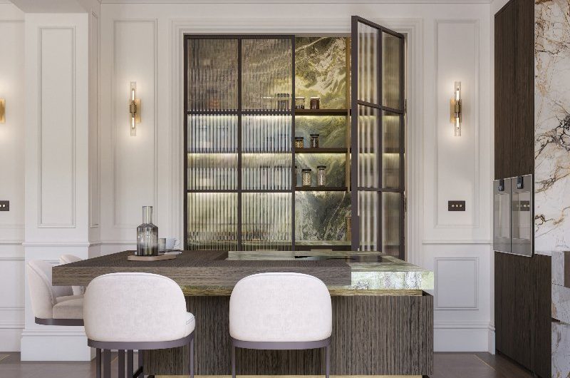 A luxury kitchen design with a striking island made from wood with green marble and seating.