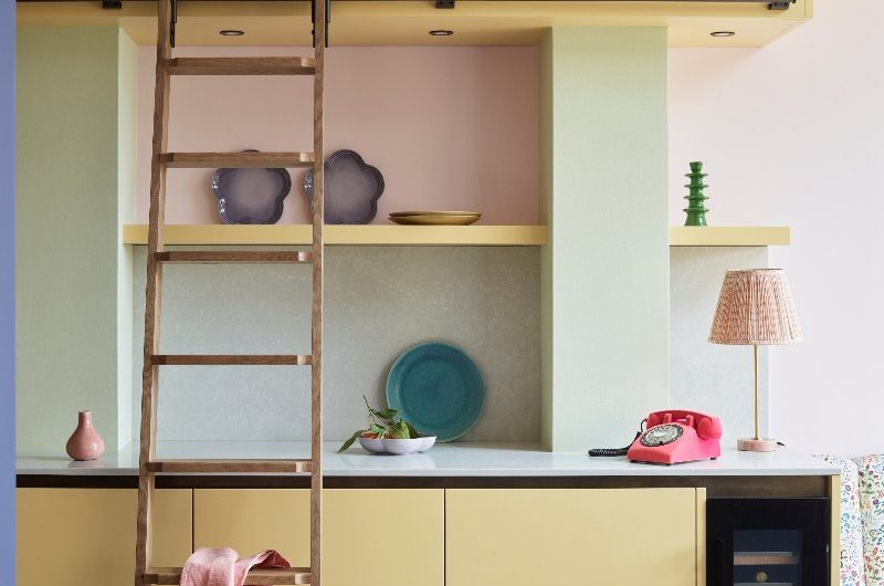 Pastel interiors with a wood rolling ladder and quirky decor.