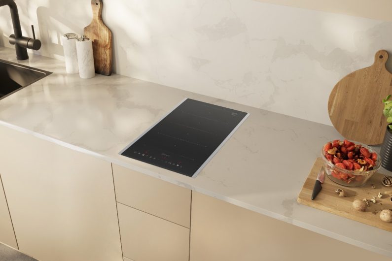 A Scandi kitchen with a domino induction hob and veiny worktops.