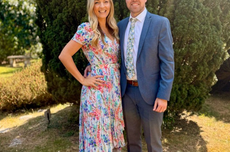 Georgina and her husband in a summer garden.