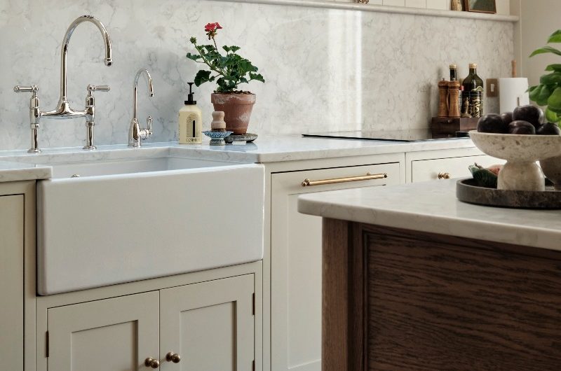 A classic design with Shaker cabinetry, butler sink, chrome tap, marble surfaces, tongue and groove panelling, wood work table and country chic decor.