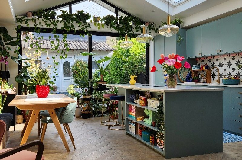 Open-plan kitchen-diner renovation project with blue cabinetry, glazing, and skylights.