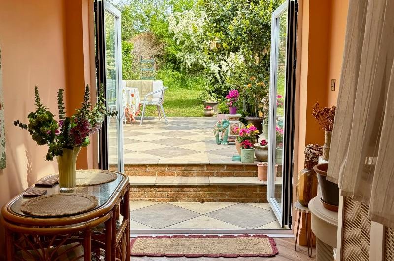View out into the garden through a back wall with herringbone flooring.