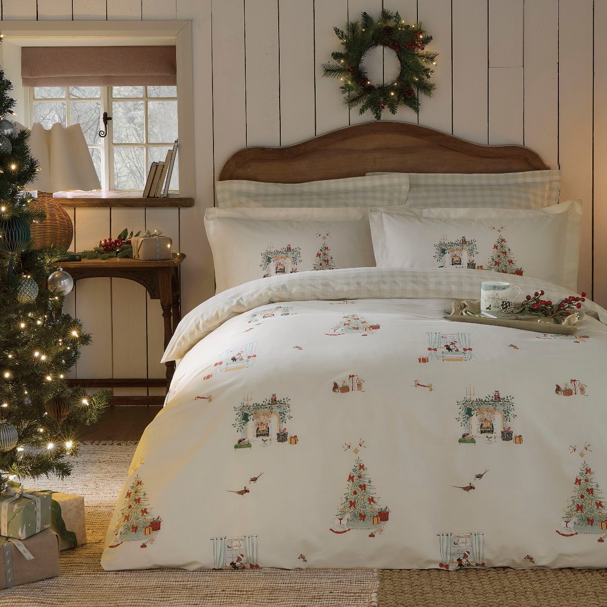 A magical Christmas bedroom with cosy bedding and a festive tree.