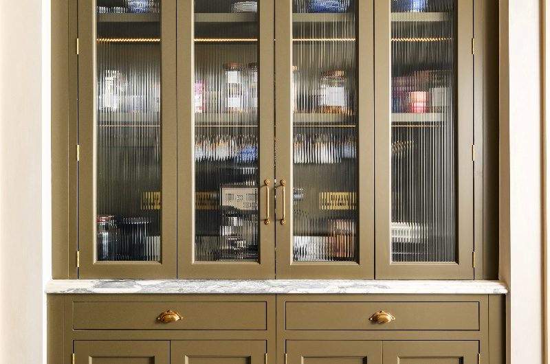 A breakfast dresser with fluted glass, marble, and brass hardware.