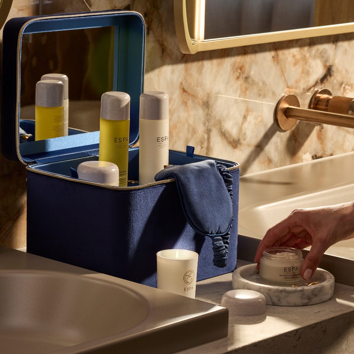 A luxurious bathroom with a blue vanity case with skincare.