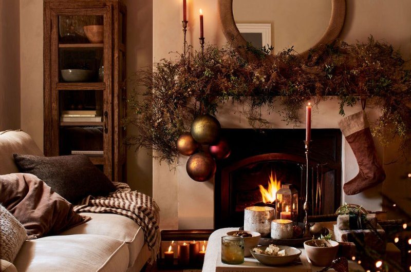 A rustic living room decorated for Christmas with dried foliage and extra large baubles.