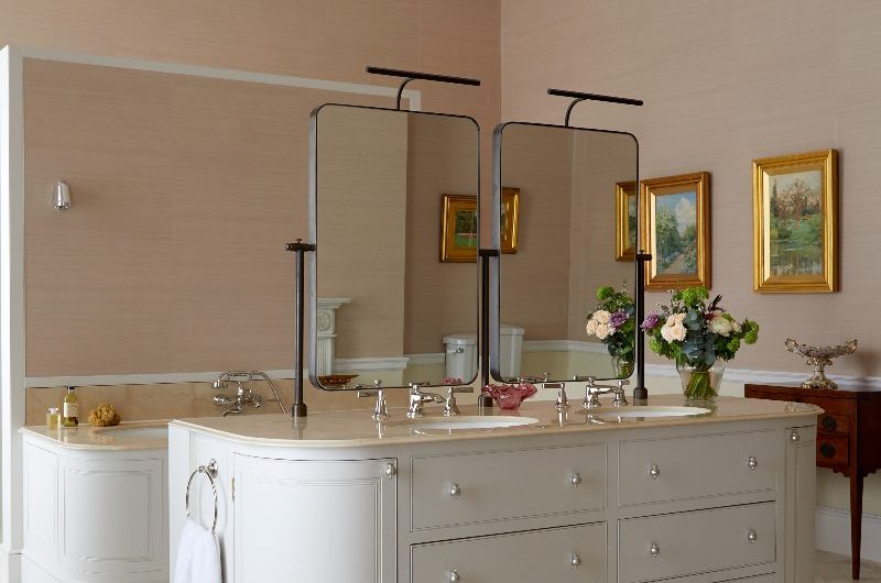 A neutral bathroom with layered textures, from a large double vanity unit, wall art, to elegant finishes and classic detailing.