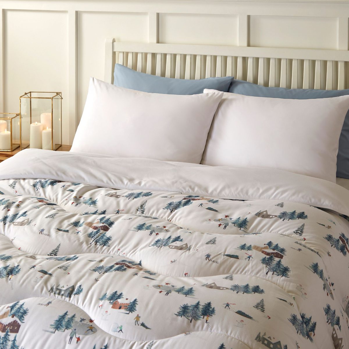 A calm and neutral scheme with a coverless duvet and white and blue pillowcases.